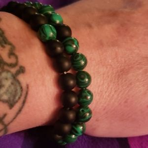His and hers green agate and lava bracelets.